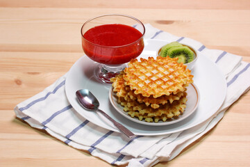 sweet waffles, kiwi slices and strawberry jam.