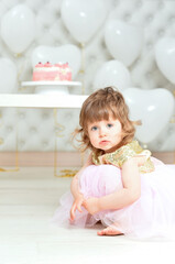 Fototapeta na wymiar Portrait of baby girl with cake on her birthday