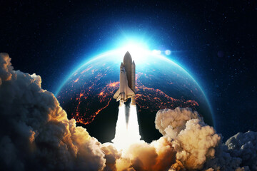 Fototapeta New space rocket lift off. Space shuttle with smoke and blast takes off into space on a background of blue planet earth with amazing sunset. Successful start of a space mission. Travel to Mars obraz