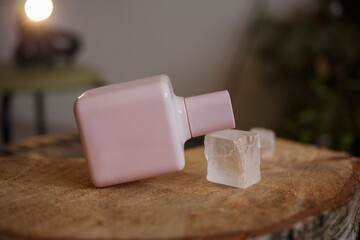 A bottle of perfume in the hands of a girl
