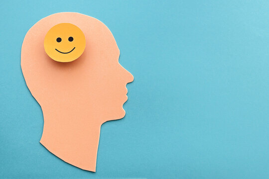 Human head with a positive round sign in the brain. The concept of good mood and mental health.