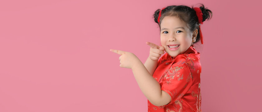 Smiling cute asian little child girls in red chinese traditional dress.Happy Chinese new year concept.