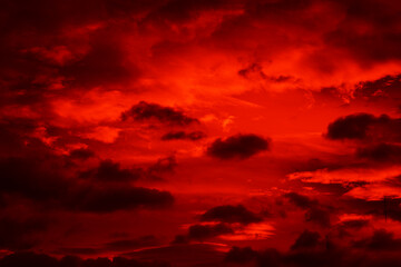 Bright red sunset. Dramatic evening sky with clouds. Fiery skies with space for design. Magic...