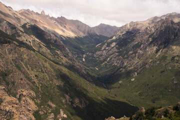 Alpine landscape. View of the green valley, forest and mountains form the top of Bella Vista Hill in Bariloche, Patagonia Argentina. 