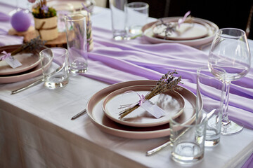 Table setting with sparkling wineglasses, plate and cutlery on table, copy space. Place set at wedding reception. Table served for wedding banquet in restaurant