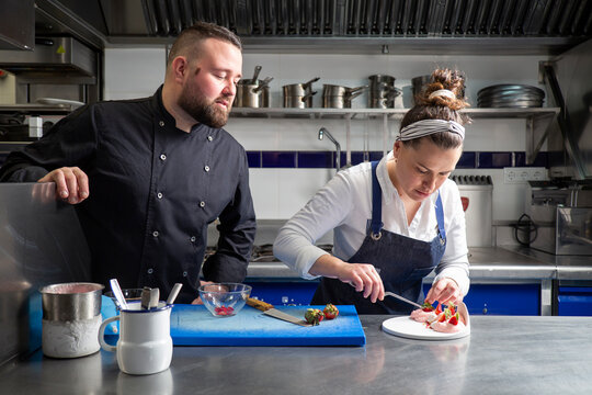 Cheerful chefs cooking dessert together