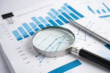 Magnifying glass on charts graphs paper. Financial development, Banking Account, Statistics, Investment Analytic research data economy, Stock exchange trading, Business office company meeting concept.