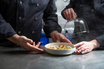 Crop cooks serving dish together