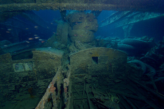 Abandoned rusty ship and tropical fish in sea