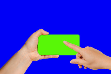 Young woman tapping on empty smartphone screen with green chroma key, the device is positioned slightly turned