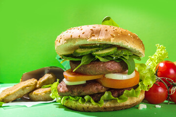 Vegan burger with plant-based green or lab-grown burger cutlet, fresh vegetables and organic healthy sauce, copy space