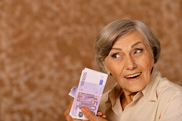 Happy  elderly woman with euros