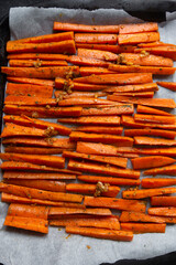 Sliced carrots with garlic and herb, ready to bake. Vegan food