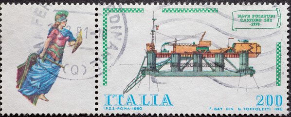 Italy - circa 1980: a postage stamp from Italy showing a modern offshore platform and historical...