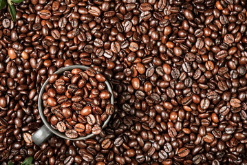 Coffee background with space for text, layout of coffee beans on the table and black cup for...