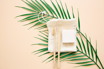 Eco-friendly bathroom accessories: bamboo toothbrushes, organic soap, body washcloth on a beige background. Shopping without waste. Waste free life.