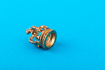 Small golden crown on blue background.
