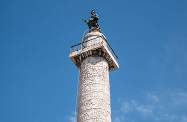 Trajan's Column (Colonna Traiana) with a bronze figure of Saint Peter the Apostle. Roman triumphal...