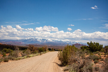 A dirt road leading to the mountains in Arches National Park in Utah.