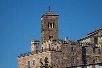 Fototapeta premium Bell tower of The Santa Maria Assunta Cathedral(Sutri)is one of the few remains of the medieval church, from the single lancet window on the lowest floor to the four lancet window on the highest floor