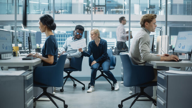Diverse Team of Managers Working and Having Discussions in Modern Big City Office. Colleagues Work on New Business Opportunities, Evaluate Financial Reports, Plan Investment Strategy.