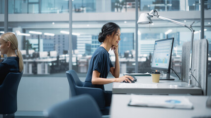 In Big Corporate Office: Beautiful Asian Business Manager Using Computer, Businesspeople and...