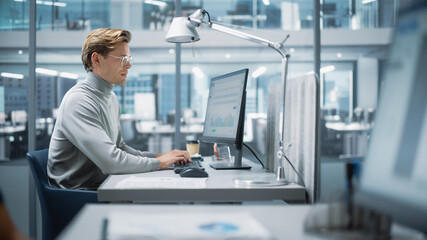 In Big Diverse Corporate Office: Portrait of Handsome Manager Using Desktop Computer, Businessman Managing Company Operations, Analysing Statistics, Commerce Data, Marketing Plans.