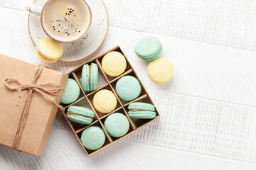 Homemade macaroons in gift box and coffee