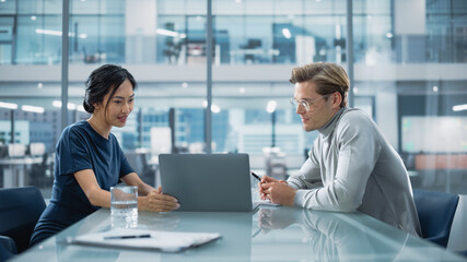 Fototapeta premium Multiethnic Diverse Office Conference Room Meeting: Team of Two Creative Entrepreneurs Talk, Discuss Growth Strategy. Stylish Young Businesspeople work on Investment and Marketing Projects.