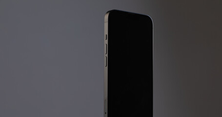 display of black rectangular modern smartphone on copy-space space on gray isolated background