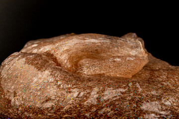 Coral transparent slime with bubbles inside on black background. Kids toy slime.