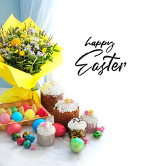 Happy Easter greeting card. Easter cakes, colorful eggs, spring flowers bouquet on table. Easter holiday concept. Festive traditional composition 