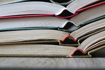 Stack of open vintage hardcover book on the table. Selective focus.