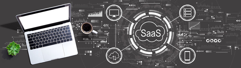 SaaS - software as a service concept with a laptop computer on a desk