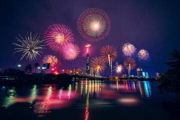 Fototapeta premium Celebration. Skyline with fireworks light up sky over Landmark 81 skyscraper in Ho Chi Minh City ( Saigon ), Vietnam. Beautiful night view cityscape.