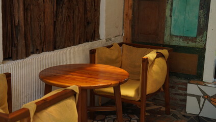 ancient armchairs and tables. a pretty interior layout of a coffee shop in a contemporary vintage theme. a cozy setting for inspo and tourism campaign.