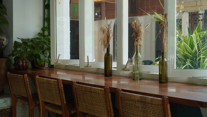 the window seat to see the outdoor view. a cozy coffee shop in a vintage theme. beautiful interior layout for inspo and social media posts.