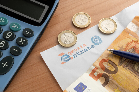 Letter from the revenue agency (agenzia delle entrate) with a fifty euro banknote, one euro coins and a calculator