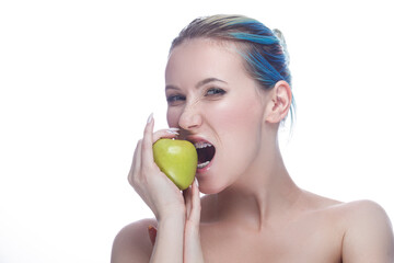 Agressive Caucasian Female with Teeth Braces and Smooth Skin Posing With Green Apple As Dental Care Ideas Against White.