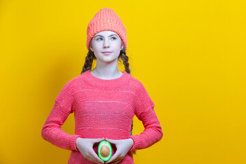 Portrait of Young Caucasian Female Holding Split Avocado Fruit As a Demonstration of Female Fertil...