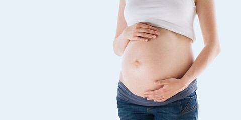 Pregnant woman isolated over grey color background