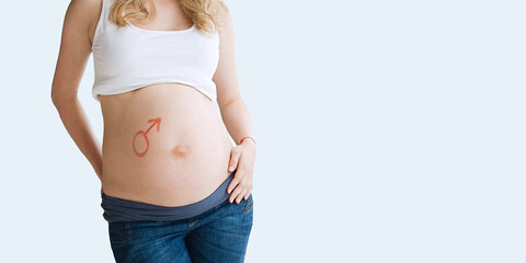 Picture on the belly of a pregnant woman gender symbol Mars. Soon will be born a boy.