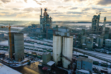 Aerial view of cement plant with high factory structure and tower crane at industrial production...