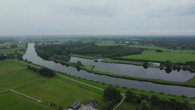 Aerial top view of a city in Holland, surrounded by houses, green trees and canal