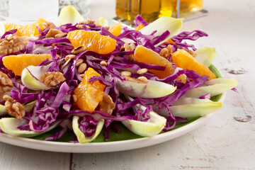 Delicious red cabbage salad with endive and orange fruit