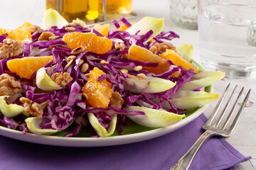 Seasonal salad of red cabbage, endive and orange fruit