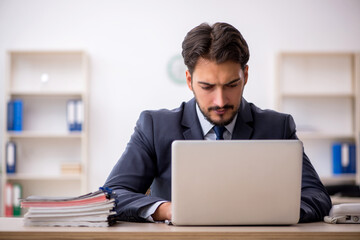 Young male employee working in the office