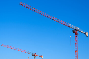 Tower cranes against blue sky