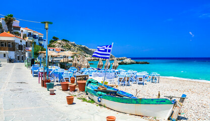 Samos island, Greece. Beautiful beach and tavern in scenic Kokkari village. popular tourist destination for summer holidays
