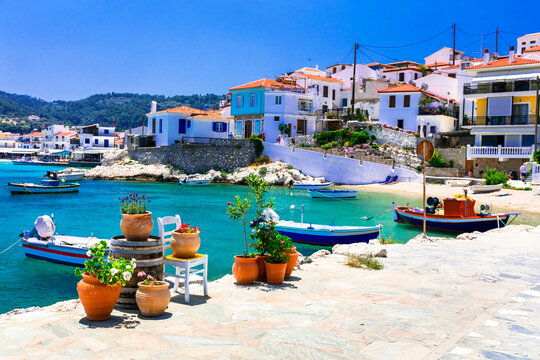 picturesque village of Kokkari, one of the Most Beautiful Towns of Samos, Greece. Idyllic turquoise sea & fishing boats with floral decoration on the empty streets, Hidden gems Greece